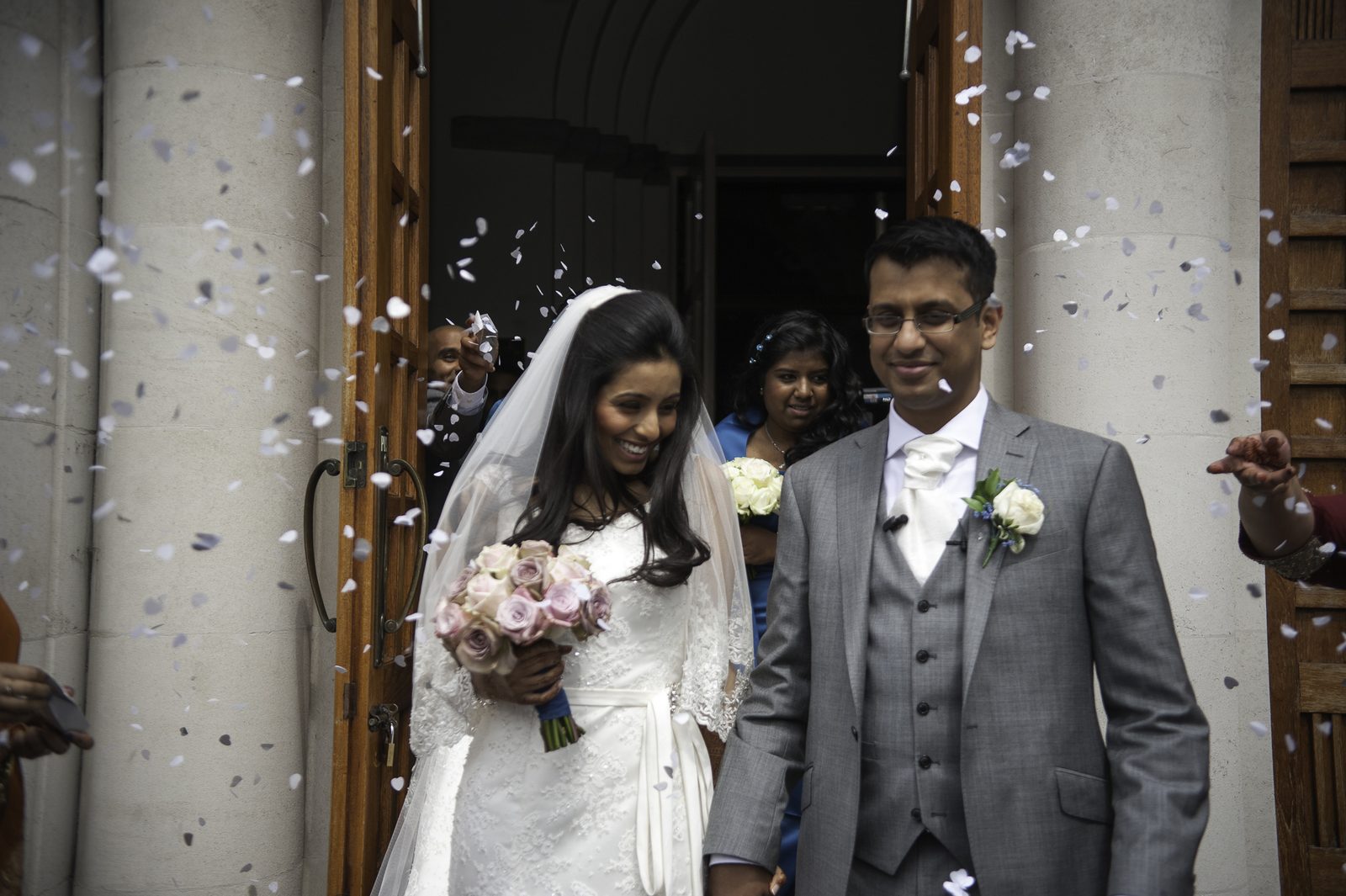 Confetti thrown over the couple in the church doorway after an Indian Christian wedding ceremony