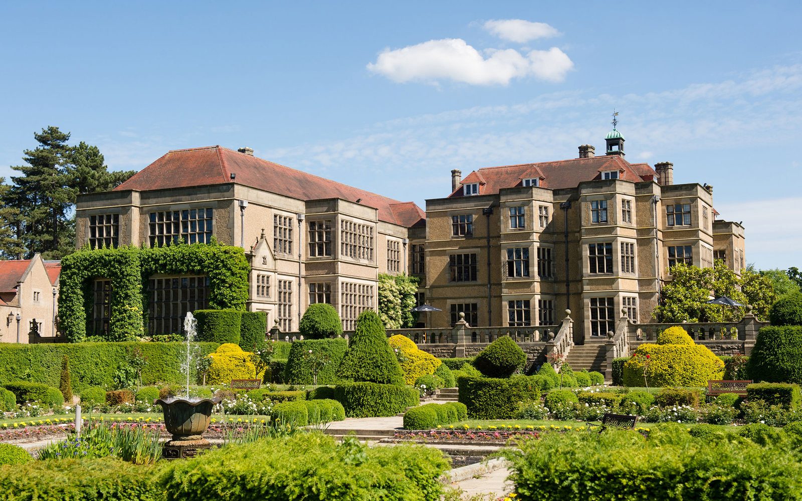 Fanhams Hall in Ware, Hertfordshire, seen across its formal box gardens