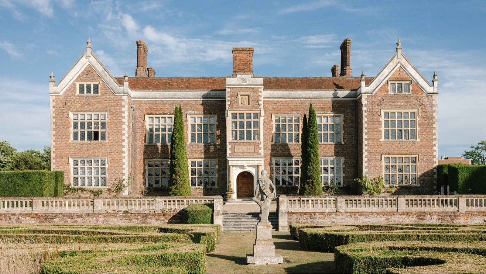 The Grade I Elizabethan style house at North Mymms Park in Hatfield, Hertfordshire, seen across its formal gardens